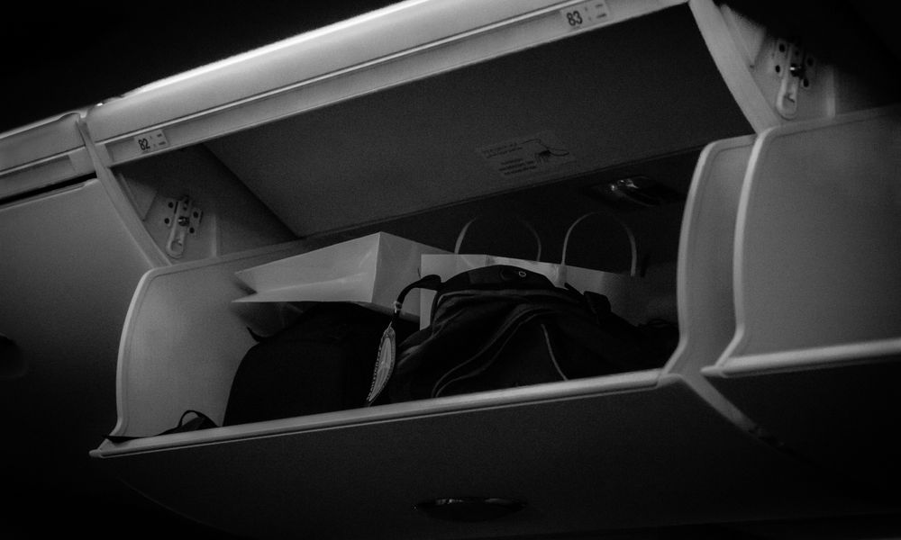 Luggage stowed in an aircraft overhead bin